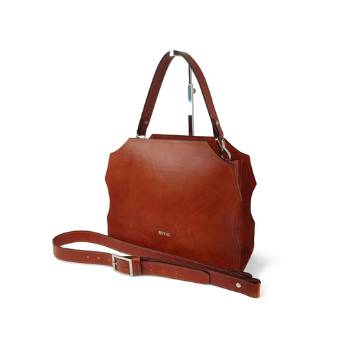 Handmade custom leather satchel with adjustable shoulder strap, bespoke craftsmanship and personalization