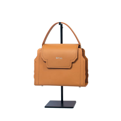 Hope hand‑painted full‑grain leather crossbody in tan with a refined, bespoke small silhouette on a display stand.