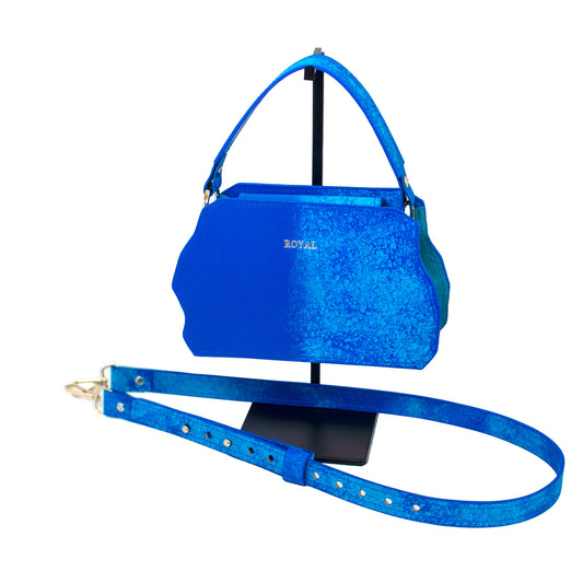 Victorious leather crossbody bag on stand. Structured silhouette with a removable full-grain leather strap.